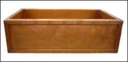copper farmhouse sink with hammered copper strapping and rivet border