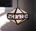 Copper structure and decorative wrought iron vine and leaf patterned pendant fixture with white glass diffusers.