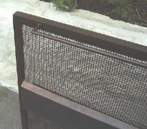Close up of contemporary fire screen showing handle and angled edge of center band