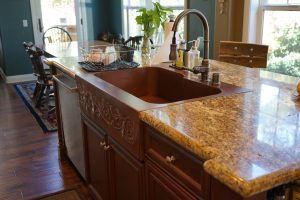 Offset Basin Farmhouse Sink with custom repoussé apron