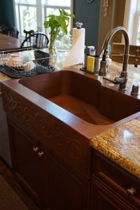 Offset Basin Farmhouse Sink with custom repoussé apron